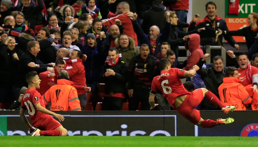 Liverpool's Philippe Coutinho, left, and Liverpool's Dejan Lovren celebrate after scoring the winning goal during the Europa League quarterfinal second leg soccer match between Liverpool FC and Borussia Dortmund in Liverpool, England, Thursday, April 14, 2016 . (AP Photo/Jon Super)